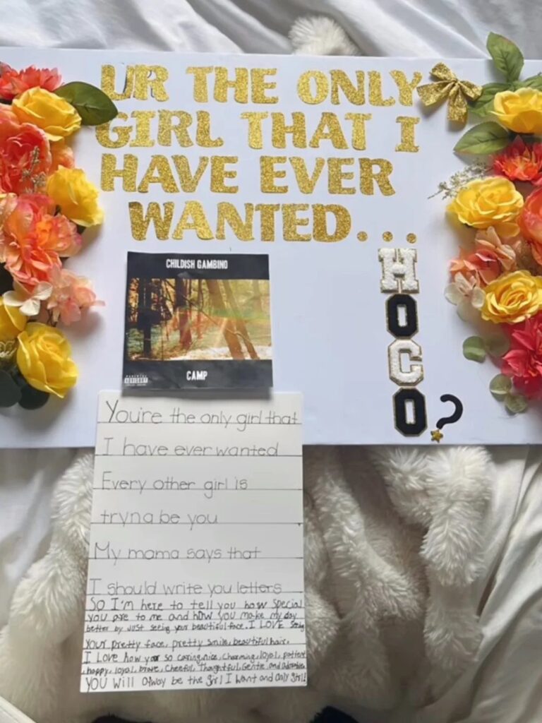 Homecoming proposal poster with gold glitter text, red and yellow roses, and a letter.